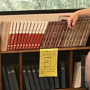 a person sitting in front of a bookshelf