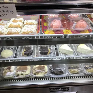 a variety of pastries in a display case