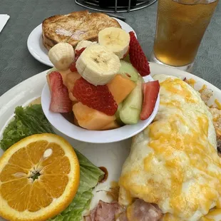 Egg white ham and cheese omelette, fresh fruit, sourdough bread, iced tea