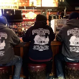three men sitting at the bar