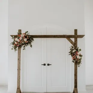 This is a wood frame arch that you can rent for your wedding altar that we added florals to