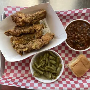 Fried wings with green beans and baked beans.