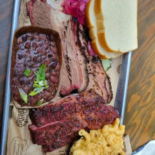 Brisket, ribs, beans, mac and cheese, potato bread, onions and cucumber.