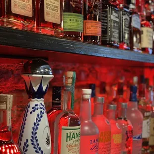 a shelf of liquor bottles