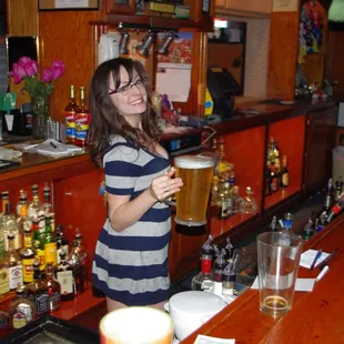 a woman holding a pint of beer