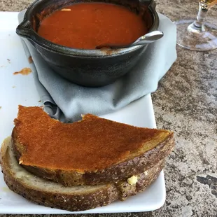 Tomato soup and grilled cheese (already ate half the sandwich)