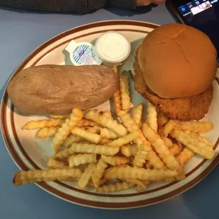 Delicious crispy chicken sandwich with fries and baked potato!