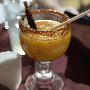 a drink with a cinnamon stick in it