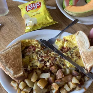 Bacon and egg omelette with toast and home fries‍
