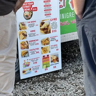 two men standing next to a food truck