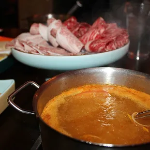 Our Hot Pot Soup bases were brought out and set on our tables burners to heat up.