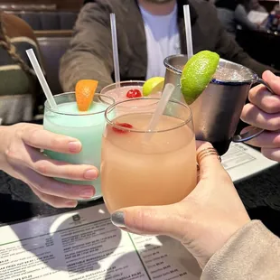 two people toasting drinks