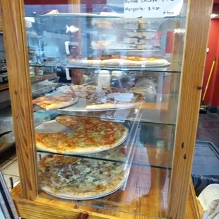 pizzas in a display case