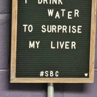 a sign saying sometimes i drink water to surprise my liver