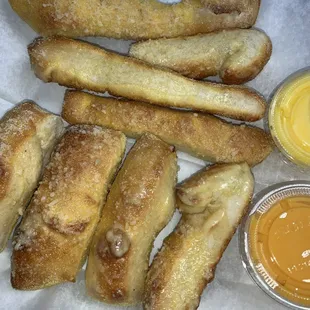 Homemade breadsticks with cheese and garlic butter.  They are made using their own dough.  No dip needed.