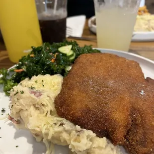 Chicken schnitzel, cheesy garlic mashed, and kale side.