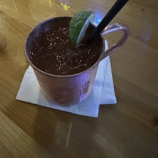 a chocolate drink with a lime garnish