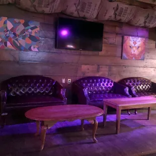 a living room with purple couches