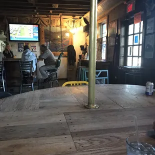 A view from 1 of the 4 tables, looking at the entrance and a dancing pole affixed to this table.