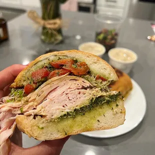 a person holding a sandwich