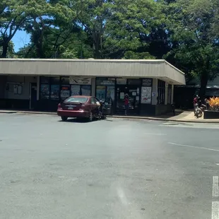 a red car parked in front of a store