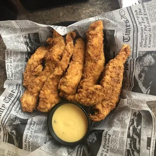 Chicken tender appetizer with honey mustard.