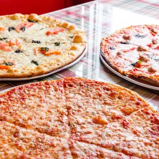 three pizzas on a table