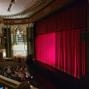 a stage with a red curtain