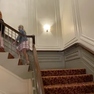 two children walking up the stairs