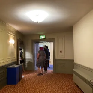 two people walking down the hall