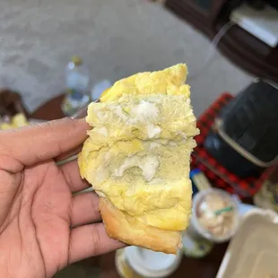 a person holding a piece of bread