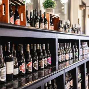 a row of wine bottles on a shelf
