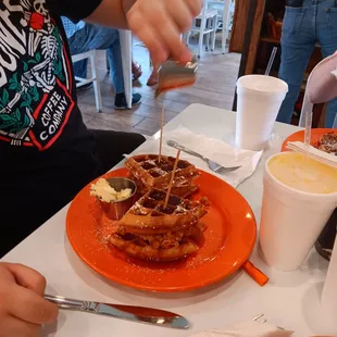 a plate of waffles and a cup of coffee