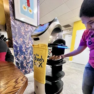 a young girl using a brunch box