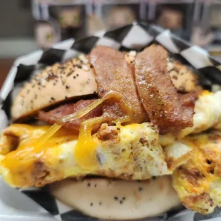 Chorizo an egg on an everything bagel with bacon and sausage