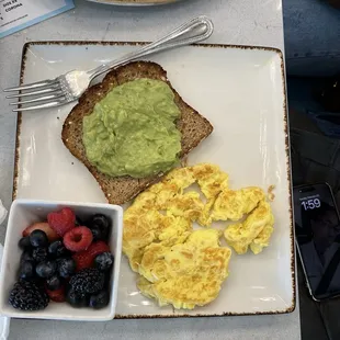 Avocado toast, eggs and a side of berries