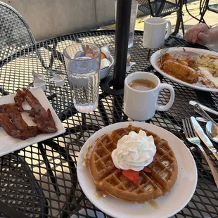 Dulce de Leche waffle with strawberries, side of bacon and chile rellano and eggs. And coffee.