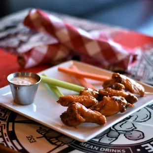 The Wings - Smoked or Fried with choice of Dry Rub, Spicy Buffalo, Honey BBQ, or Garlic Sriracha. Served w/ Ranch or Blue Cheese, Veggies