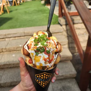  hand holding a cone of food