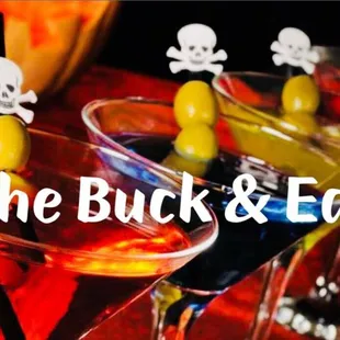three cocktails with olives in them