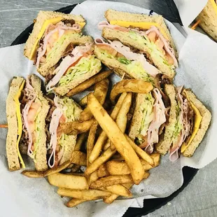 a plate of sandwiches and french fries