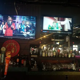 a bar with two televisions