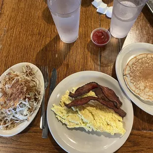 Breakfast special: 2 eggs, 2 pieces of bacon, 2 pancakes, hash browns on the side.