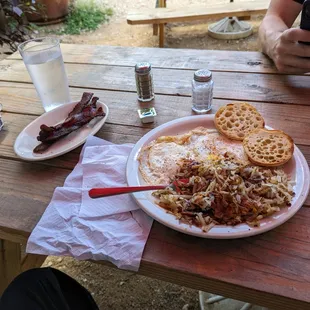 2 eggs, over easy with hash browns and an English muffin, with bacon.