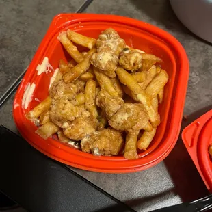 a bowl of chicken and fries