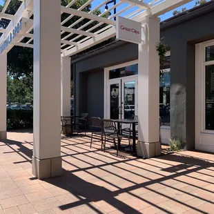 a patio with tables and chairs