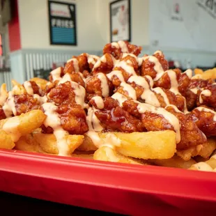 a plate of fries covered in sauce