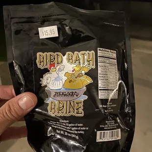 a hand holding a bag of bird bath