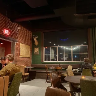people sitting at tables in a restaurant