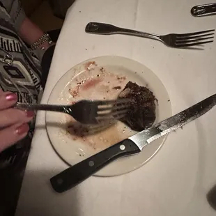 The steak had to be eaten from a salad plate because the waiter forgot to bring a plate.